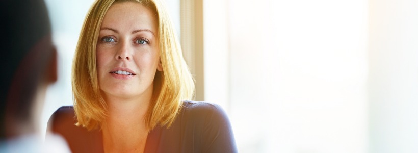 business woman listening to a coworker during a difficult Quarterly Conversation